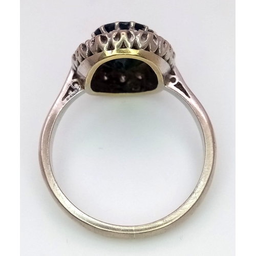 365 - An 18K White Gold, Sapphire and Diamond Ring. Central faceted oval sapphire with a round cut diamond... 