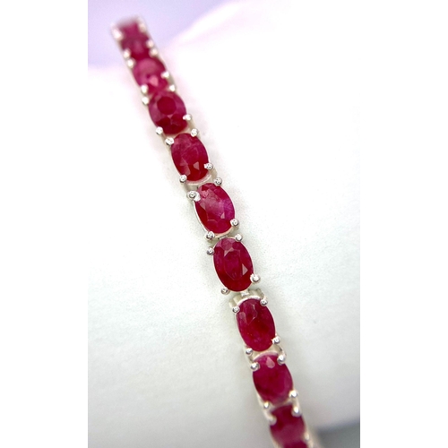 521 - An Oval Cut Ruby Gemstone Tennis Bracelet. 18cm. 14.86g total weight. Ref: CD-999.