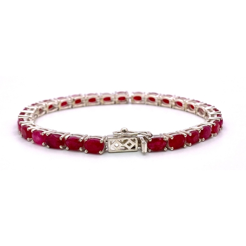 521 - An Oval Cut Ruby Gemstone Tennis Bracelet. 18cm. 14.86g total weight. Ref: CD-999.