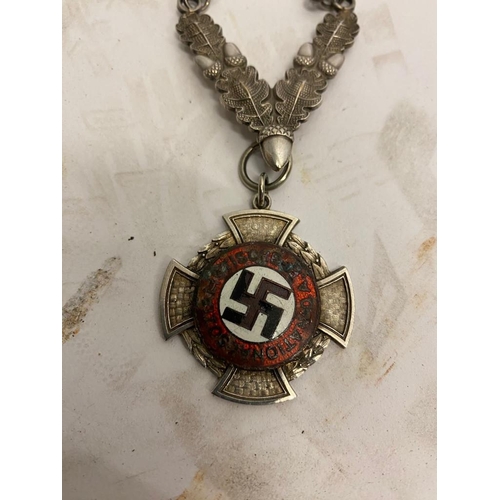 668 - A WW2 German Political Badge and Chain. The base of the chain is decorated with oak leaves. ML516