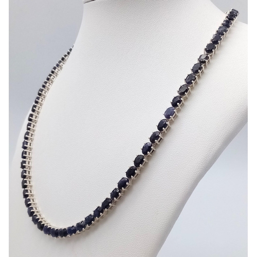 703 - A Blue Sapphire Gemstone Tennis Necklace set in 925 Silver.
46cm length. 35g total weight. Ref: CD-9... 