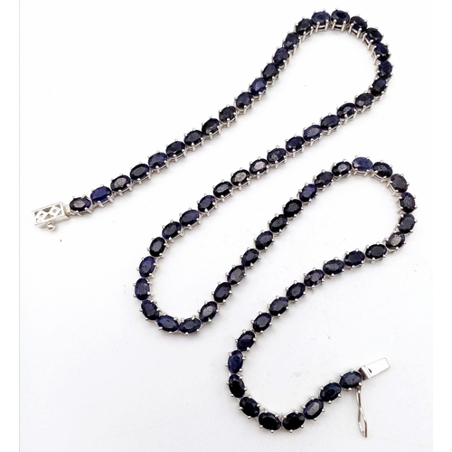 703 - A Blue Sapphire Gemstone Tennis Necklace set in 925 Silver.
46cm length. 35g total weight. Ref: CD-9... 