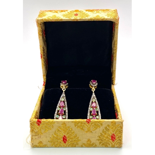 1044 - A Pair of Ruby, Emerald and Diamond Teardrop Earrings. Emeralds and rubies - 4.65ctw. Diamonds- 1.10... 