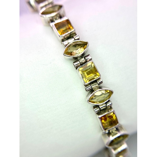 1578 - Sterling Silver Multi-Set Marquise & Princess-Cut Citrine Bracelet.
Measures 20cm in length.
Weight:... 