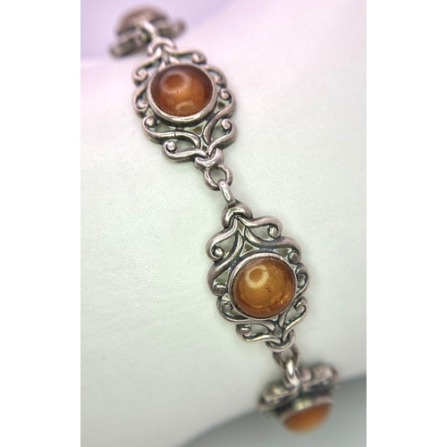 1616 - A parcel of Sterling Silver Jewellery.
Featuring an amber stone bracelet (20cm) and a purple stone r... 