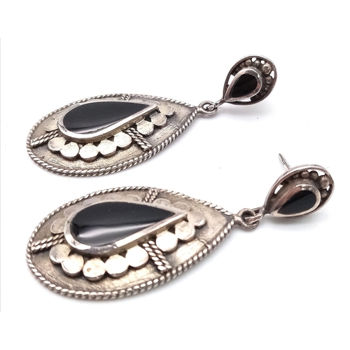 1670 - A parcel of Sterling Silver Jewellery.
Featuring a pair of tear-drop shaped drop earrings (4cm), a n... 