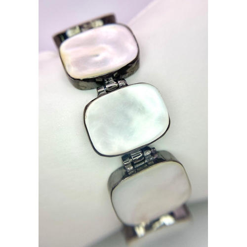 827 - A Vintage Style Mother of Pearl and 925 Silver Bracelet. Rectangular slices of MoP set in brushed si... 