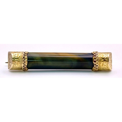 892 - A Hypnotic Antique 15K Gold Bar Brooch with Colour Change Tigers Eye. 5cm. 6.68g total weight.