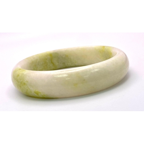 1434 - A Cauliflower Coloured Chinese Jade Bangle. 6cm inner diameter. 15mm width.