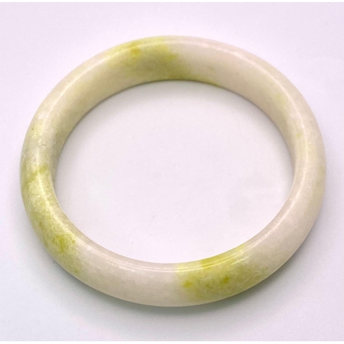 1434 - A Cauliflower Coloured Chinese Jade Bangle. 6cm inner diameter. 15mm width.