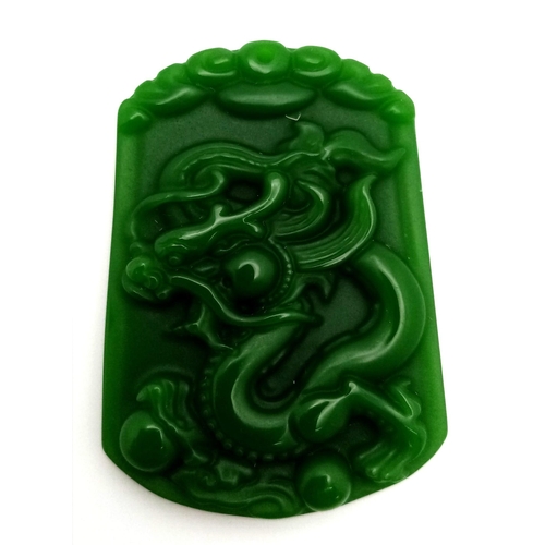 1728 - A Chinese Green Jade Decorative Dragon Pendant. 4cm