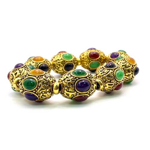 406 - A Gilded Tibetan Style Bracelet with Multi-Colour Jade Cabochon Decoration. Gilded spacers. Expandab... 