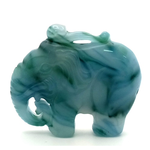 549 - A Beautiful Chinese White Jade Elephant with Splashes of Blue and Green Pendant. 5cm x 4cm.