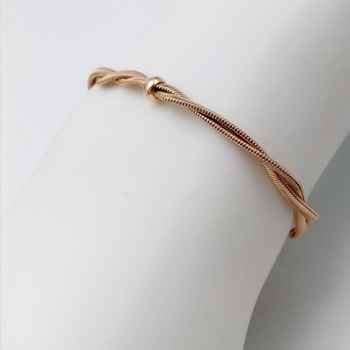 56 - An Attractive 9K Yellow Gold Crossover Bracelet. 19cm. 7.45g weight.