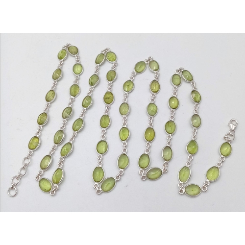 619 - An Oval Cut Peridot Gemstone Chain Necklace set in 925 Silver. 80cm. Ref: CD - 976.