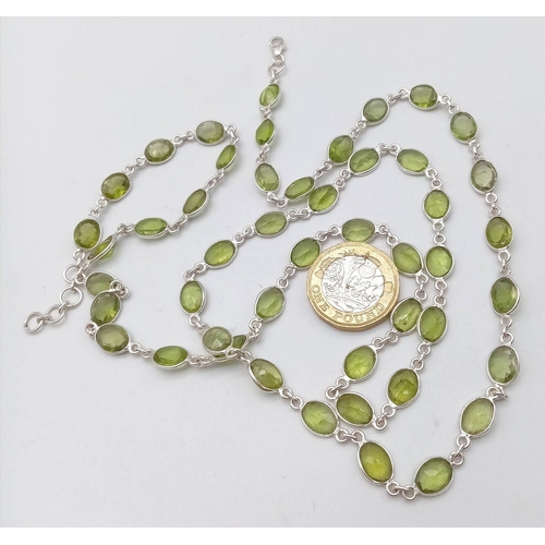 619 - An Oval Cut Peridot Gemstone Chain Necklace set in 925 Silver. 80cm. Ref: CD - 976.