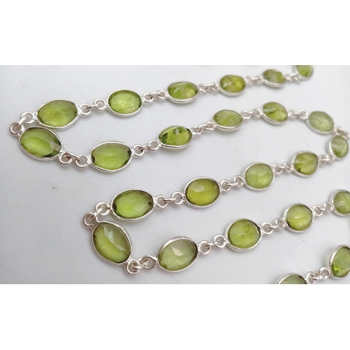 619 - An Oval Cut Peridot Gemstone Chain Necklace set in 925 Silver. 80cm. Ref: CD - 976.