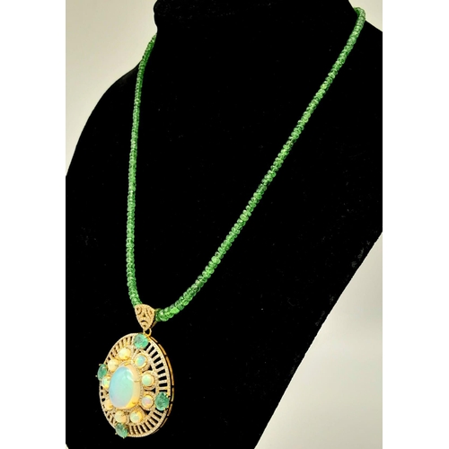 72 - A Fancy Opal, Diamond and Emerald Pendant with a Detachable Green Garnet Necklace. Centre opal with ... 