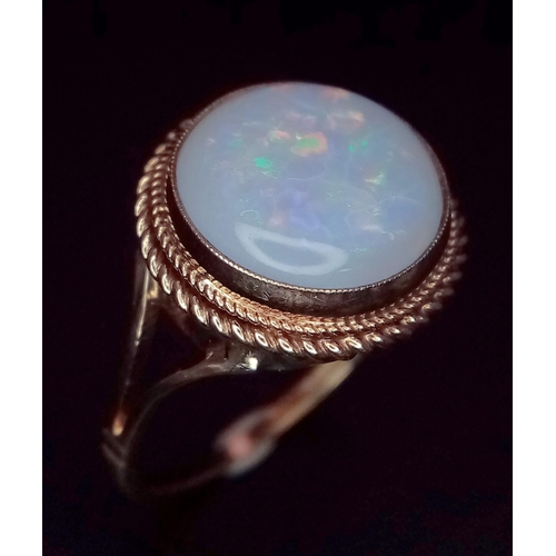 793 - A Vintage 9K Yellow Gold Opal Cabochon Ring. Wonderful colour-play. Size Q. 2.72g total weight.