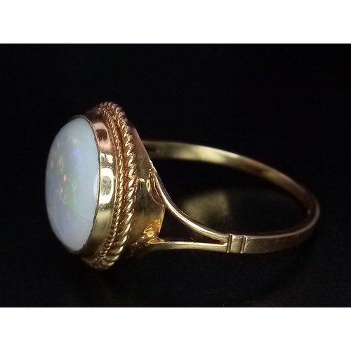 793 - A Vintage 9K Yellow Gold Opal Cabochon Ring. Wonderful colour-play. Size Q. 2.72g total weight.