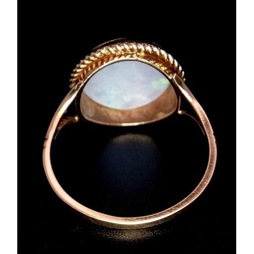 793 - A Vintage 9K Yellow Gold Opal Cabochon Ring. Wonderful colour-play. Size Q. 2.72g total weight.