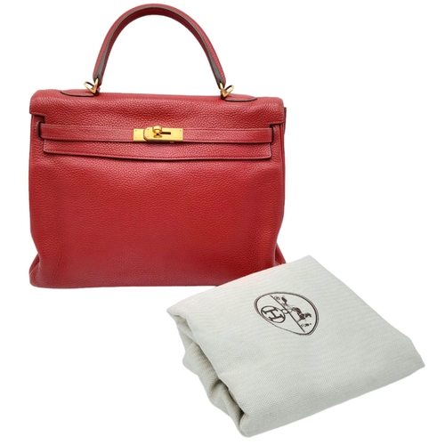 641 - A Hermes Red Kelly Bag. Veau togo leather exterior, with gold toned hardware, single handle, four pr... 