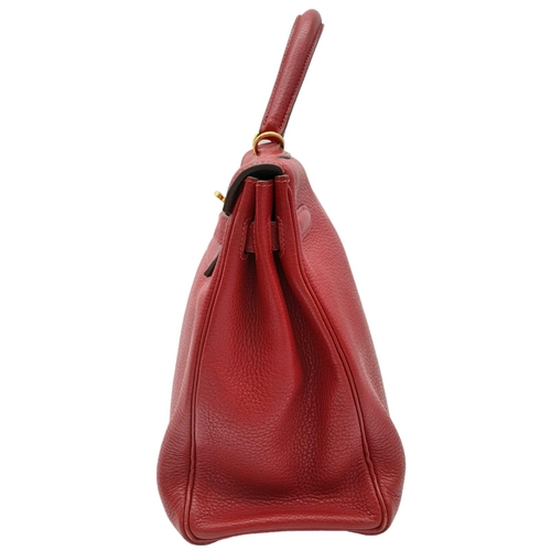 641 - A Hermes Red Kelly Bag. Veau togo leather exterior, with gold toned hardware, single handle, four pr... 