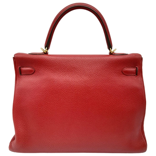 641 - A Hermes Red Kelly Bag. Veau togo leather exterior, with gold toned hardware, single handle, four pr... 