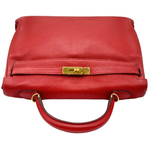 641 - A Hermes Red Kelly Bag. Veau togo leather exterior, with gold toned hardware, single handle, four pr... 