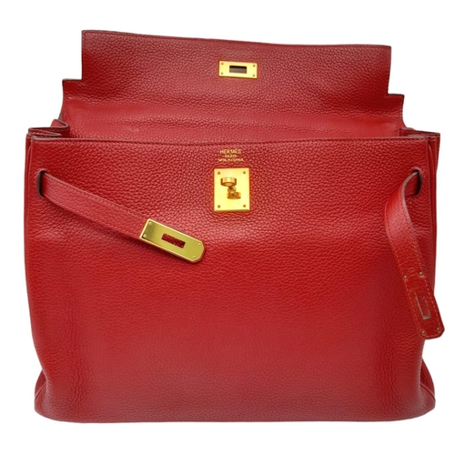 641 - A Hermes Red Kelly Bag. Veau togo leather exterior, with gold toned hardware, single handle, four pr... 