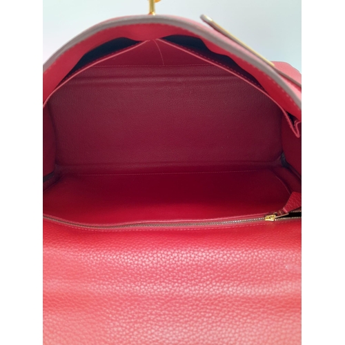 641 - A Hermes Red Kelly Bag. Veau togo leather exterior, with gold toned hardware, single handle, four pr... 