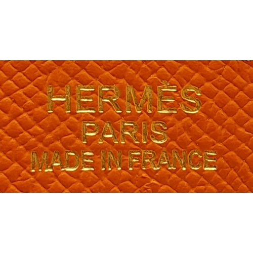 648 - Hermès Orange Togo Birkin Handbag. 
Iconic Orange paired with gold toned hardware is a brilliant pop... 