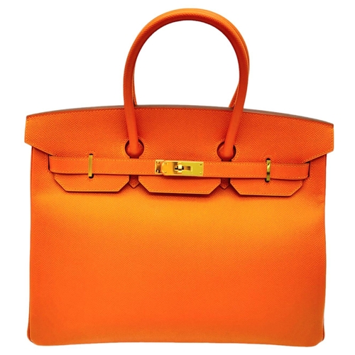 648 - Hermès Orange Togo Birkin Handbag. 
Iconic Orange paired with gold toned hardware is a brilliant pop... 