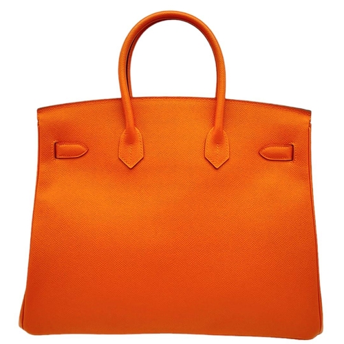 648 - Hermès Orange Togo Birkin Handbag. 
Iconic Orange paired with gold toned hardware is a brilliant pop... 