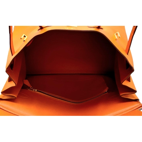 648 - Hermès Orange Togo Birkin Handbag. 
Iconic Orange paired with gold toned hardware is a brilliant pop... 