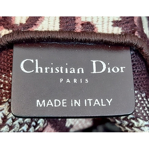 837 - A Christian Dior Burgundy Monogram Backpack. Canvas exterior, with silver toned hardware, flat handl... 