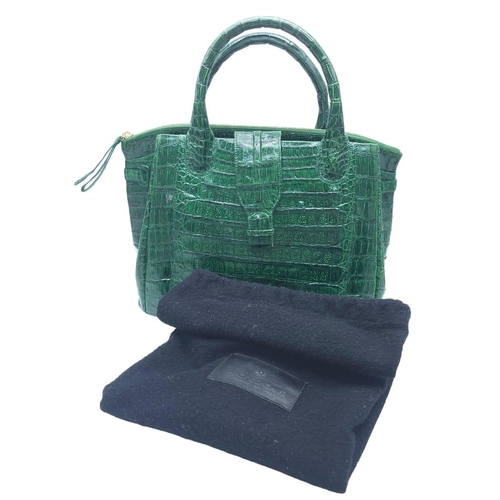 969 - Nancy Gonzalez Crocodile Handbag.
Rich, emerald green crocodile leather exterior with gold tone hard... 