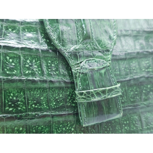 969 - Nancy Gonzalez Crocodile Handbag.
Rich, emerald green crocodile leather exterior with gold tone hard... 