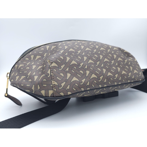 1486 - Burberry Canvas Bum Bag.
'B' monogrammed pattern with gold tone hardware. Main zip reveals sizable i... 