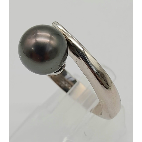 1629 - An 18K Gold (Rhodium Plated) South Sea Pearl Crossover Ring. Size N. 8.27g total weight. 10mm pearl.... 