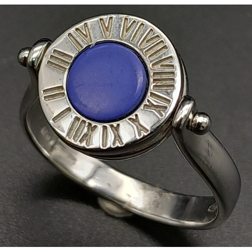 984 - An 18K White Gold 'Time Waits for No one' Swivel Ring. Blue and black enamel with roman numeral surr... 