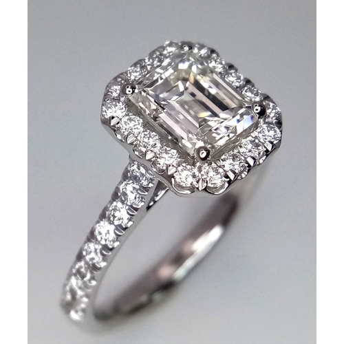 689 - A FABULOUS EMERALD CUT DIAMOND RING , A 1.29ct DIAMOND SET IN PLATINUM WITH A DIAMOND HALO AND SHOUL... 