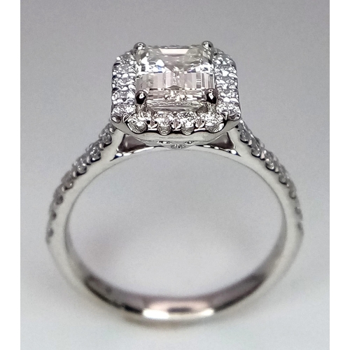 689 - A FABULOUS EMERALD CUT DIAMOND RING , A 1.29ct DIAMOND SET IN PLATINUM WITH A DIAMOND HALO AND SHOUL... 