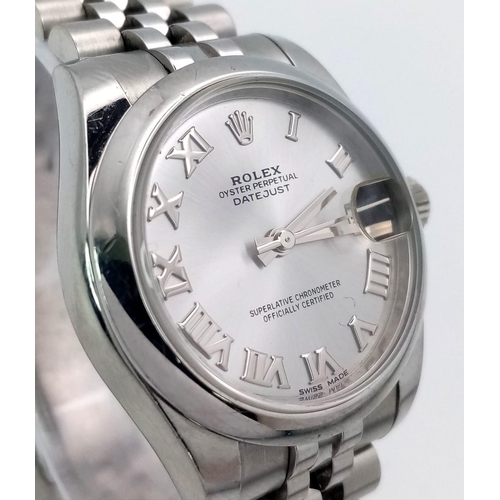 598 - A MID SIZE ROLEX PERPETUAL DATEJUST IN STAINLESS STEEL WITH SILVERTONE DIAL AND ROMAN NUMERALS .   3... 