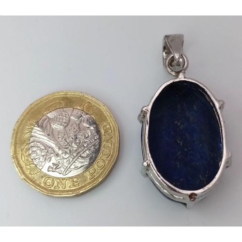 1093 - A Lapis Lazuli Cabochon 925 Silver Pendant. Oval stone on a raised foundation. 3.5cm. 8.56g total we... 