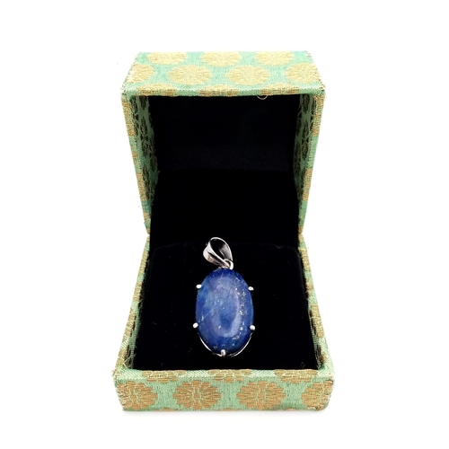 1093 - A Lapis Lazuli Cabochon 925 Silver Pendant. Oval stone on a raised foundation. 3.5cm. 8.56g total we... 