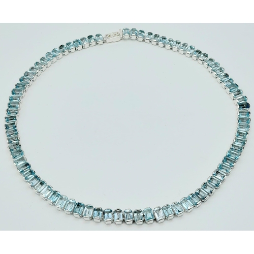 1102 - A Sky Blue Topaz Gemstone Tennis Necklace set in 925 Silver. Rectangular cut. 45cm length. 64.3g tot... 