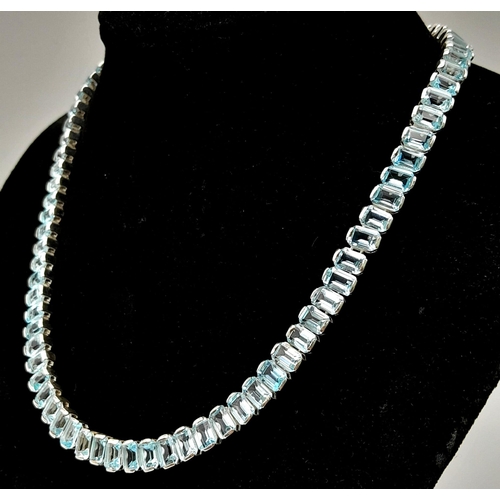 1102 - A Sky Blue Topaz Gemstone Tennis Necklace set in 925 Silver. Rectangular cut. 45cm length. 64.3g tot... 