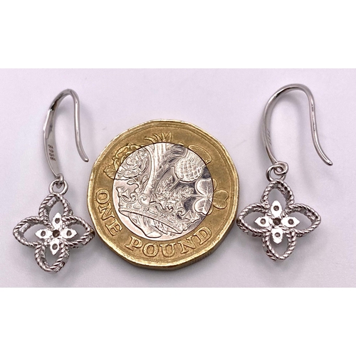 1378 - A pair of Sterling Silver Floral Design, 0.5tcw Moissanite Earrings.
Weight: 2.05g