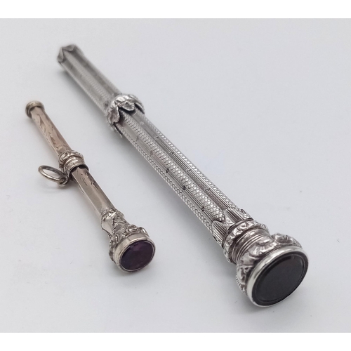 1595 - A pair of unmarked, antique jewelled Sliding Pencils.
Both ornately patterned, with scrolling featur... 